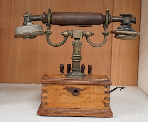 An early 20th century mahogany cased telephone, possibly by Ericsson, with handset on decorative cradle and five switchboard selector levers, stamped ‘Patent’ to front of the case, and with paper label underneath reading